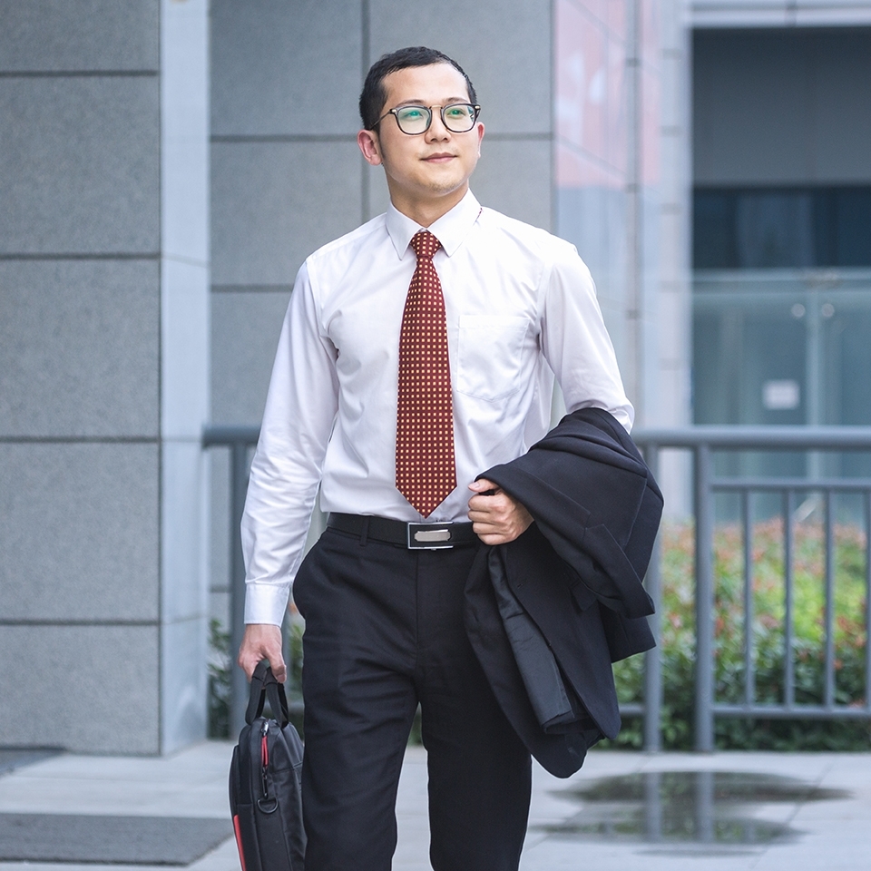 young businessman walking outside office