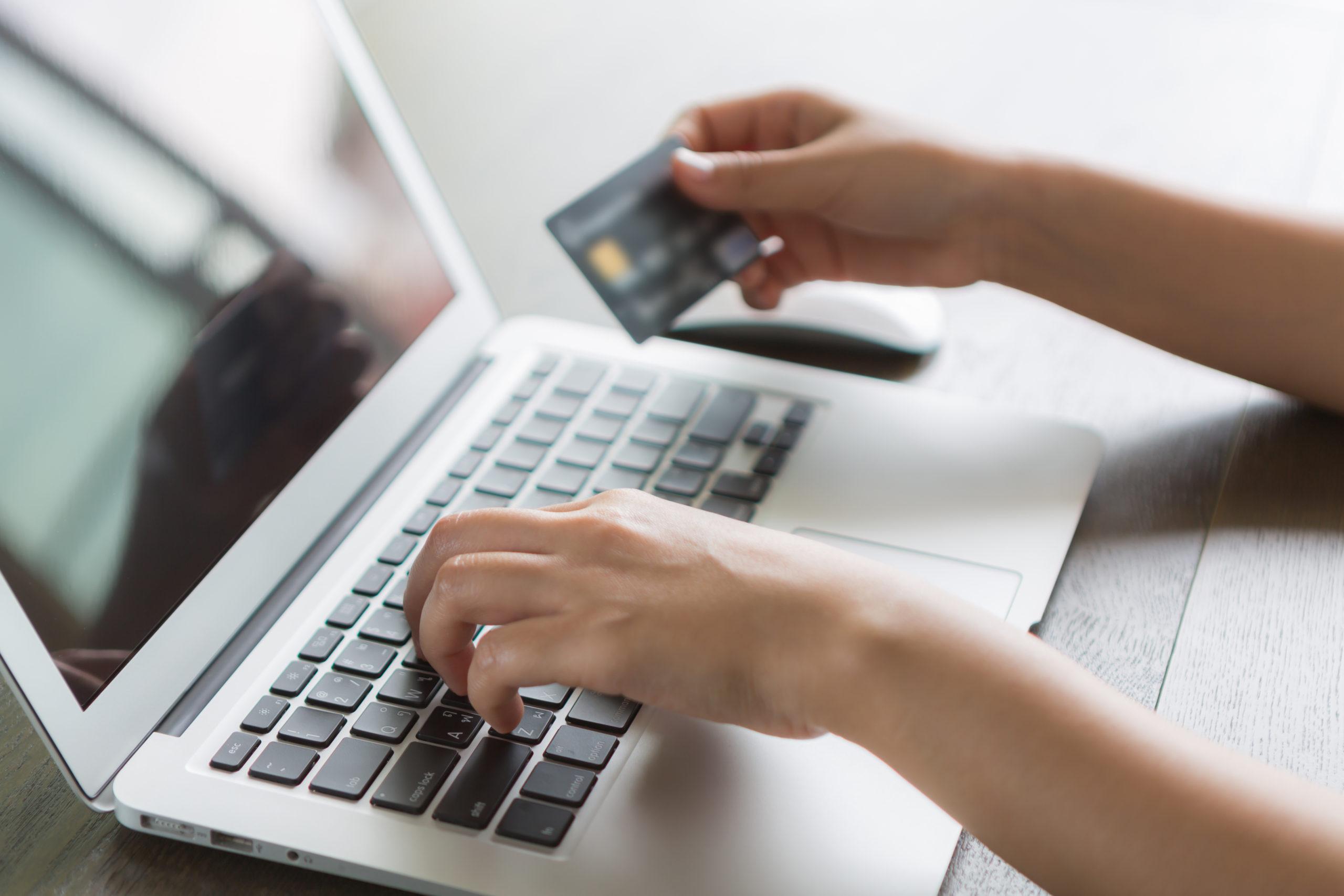 Hands holding a credit card and using laptop computer for online Next Best Product Recommendation