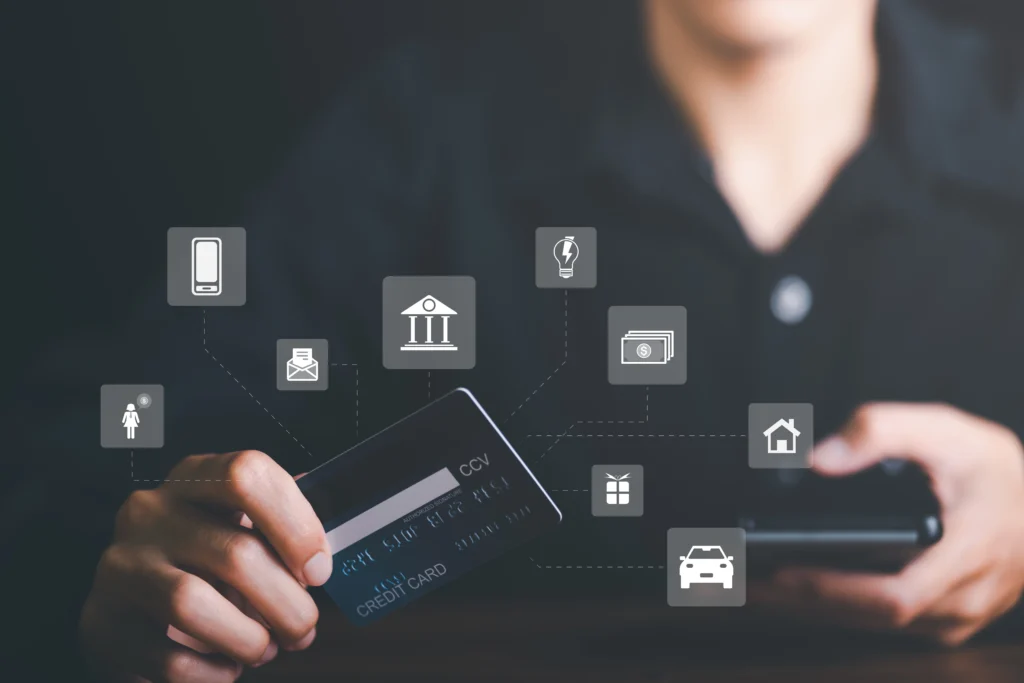 young businessman using credit card to make financial transactions via smartphone