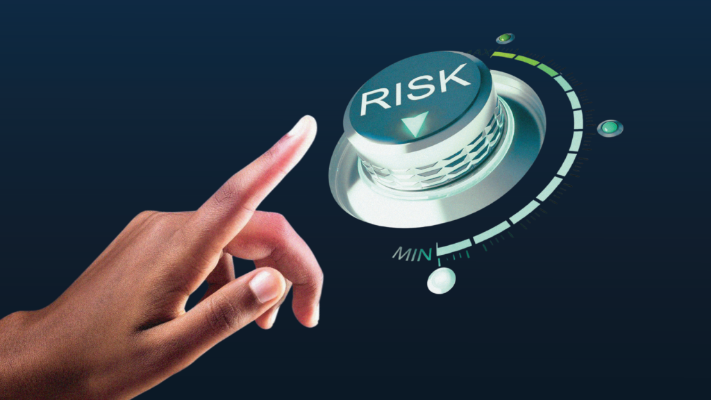 Hand adjusting a digital dial labeled “Risk” toward minimum, symbolizing proactive risk reduction and controlled exposure in financial systems.
